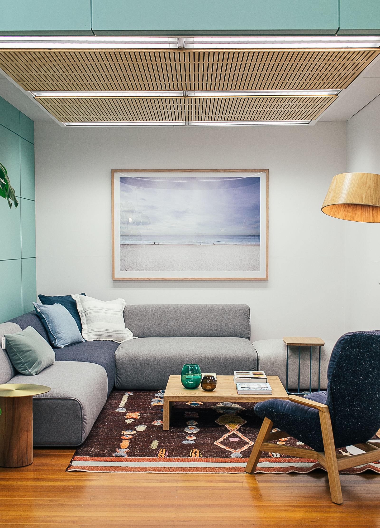 Living room with a soft couch, armchair and wooden furniture details