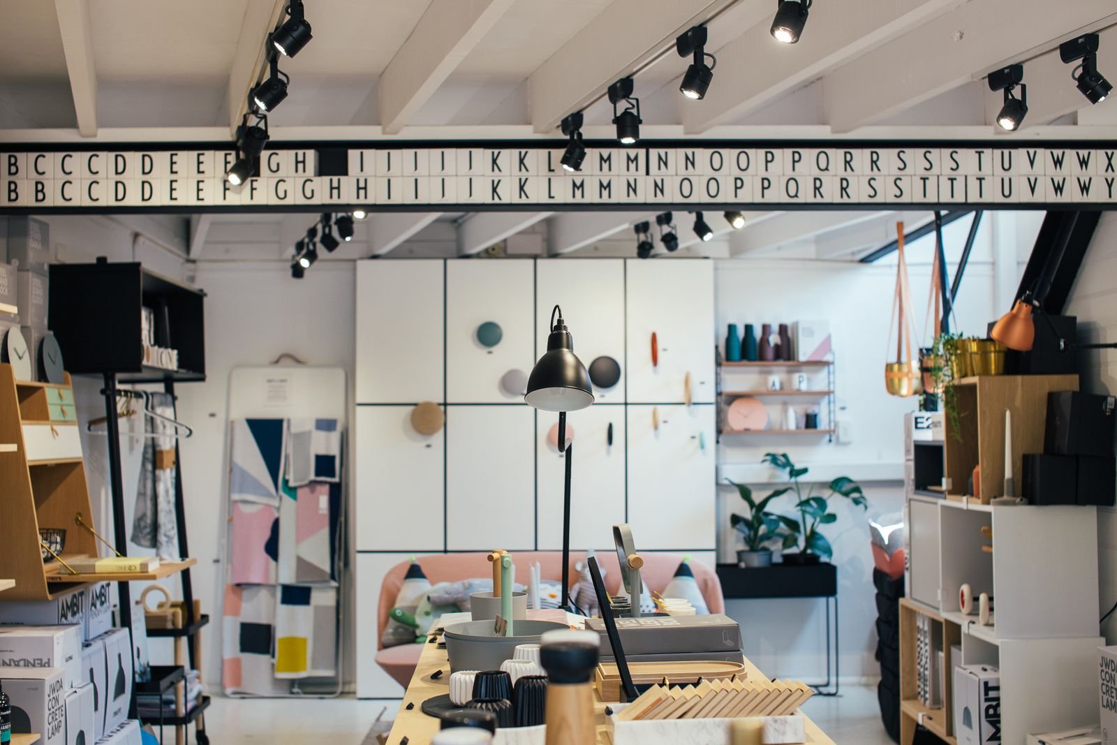 Interior of a home goods store with furniture and decor arranged across display shelves
