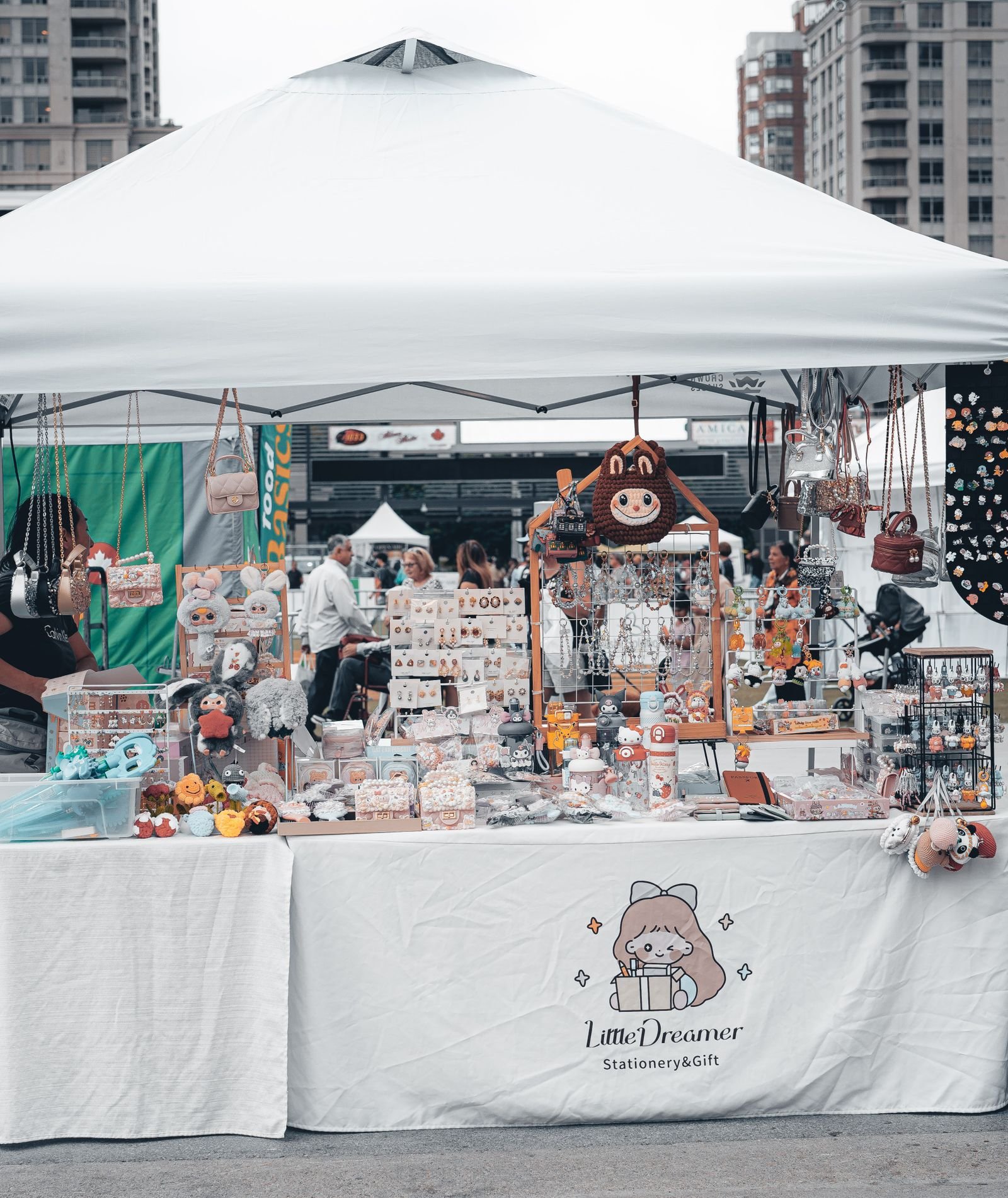 Outdoor market booth with colourful goods displayed at a street festival