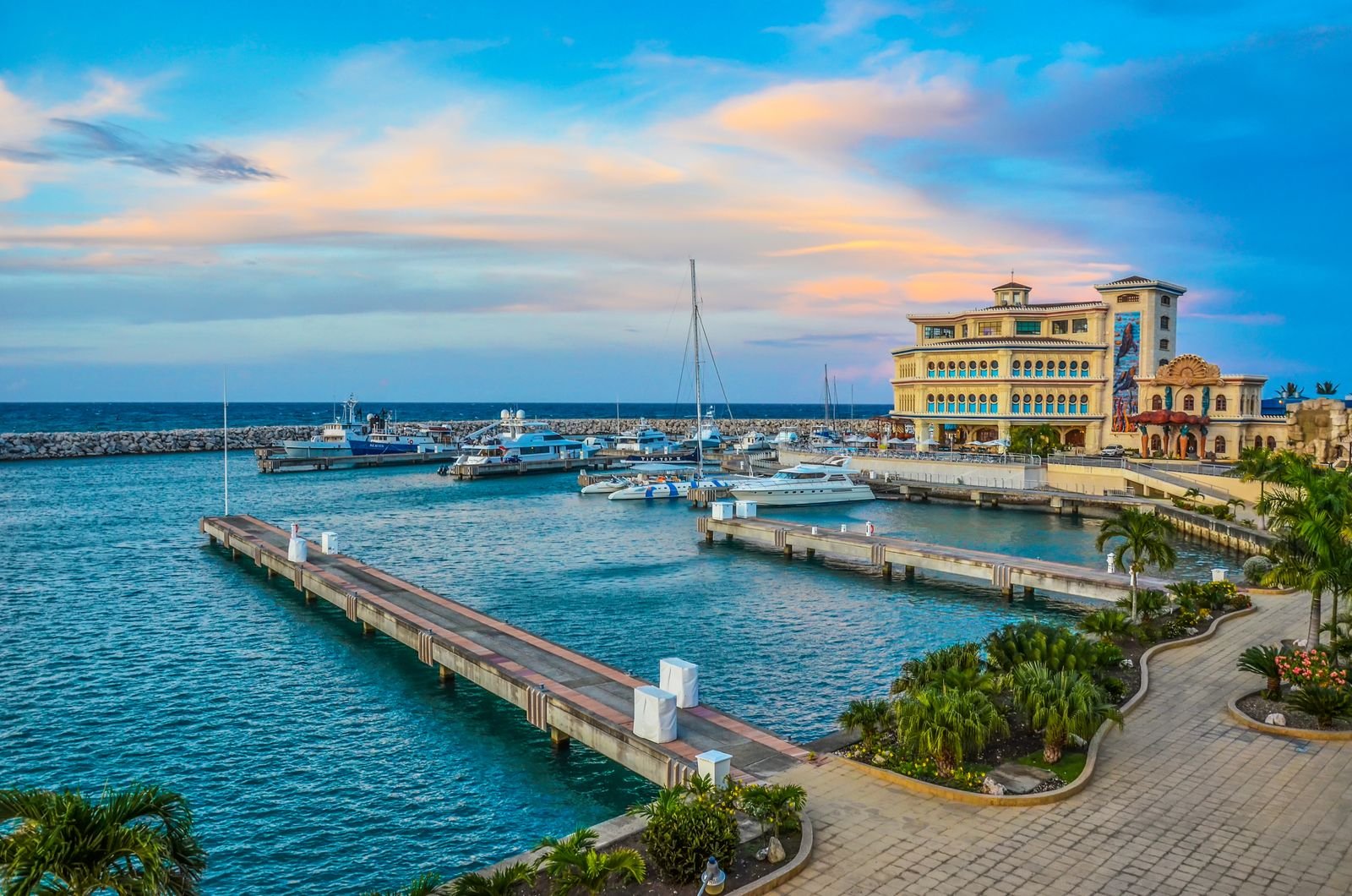 Aerial view of boats docked in a marina beside a waterfront resort