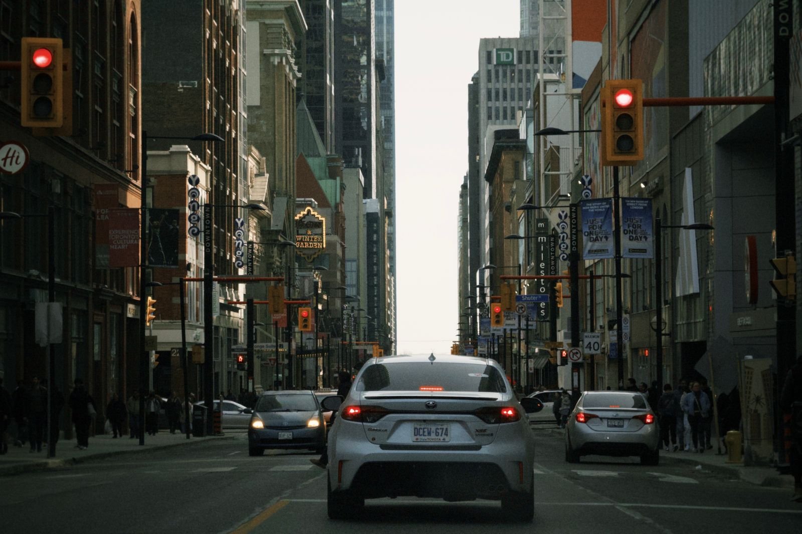 Downtown street scene with traffic and tall buildings on both sides