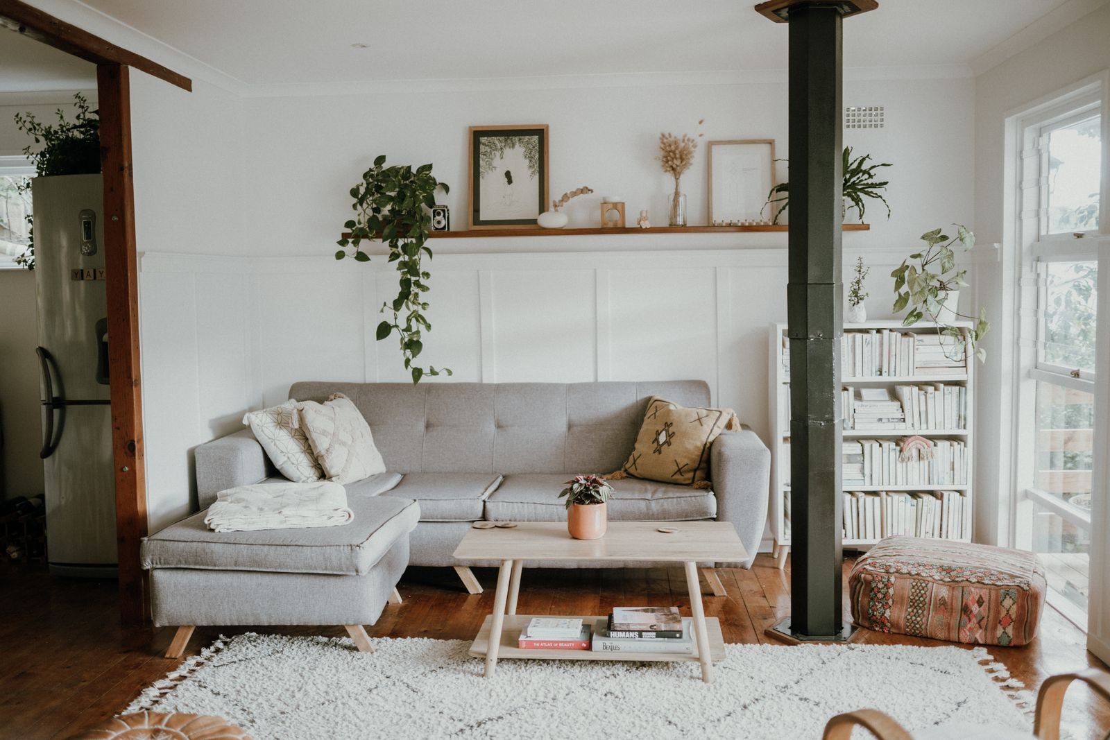 Bright Scandinavian-style living room with a light sofa and houseplants