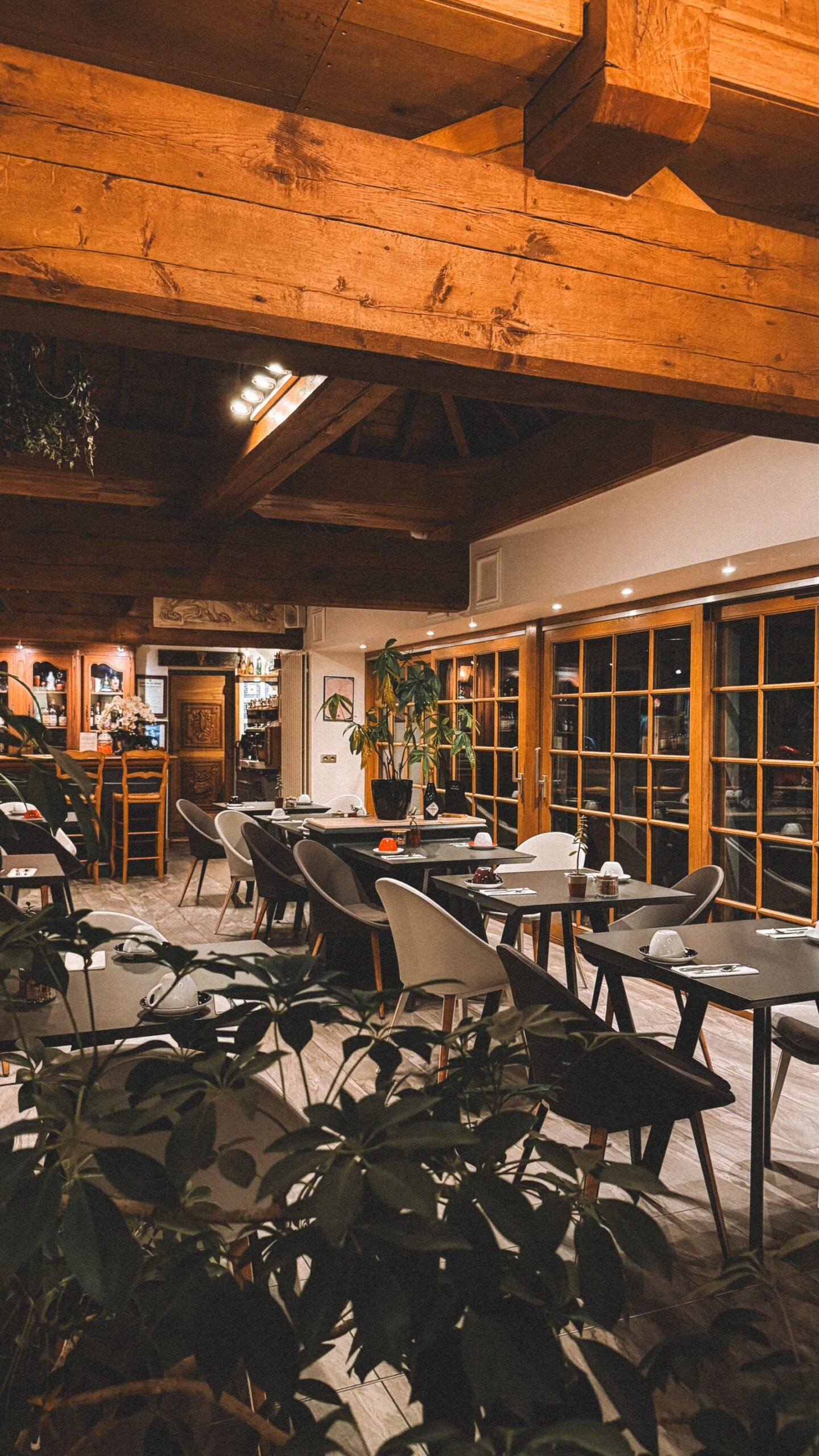 Rustic restaurant interior with exposed wooden beams and banquette seating