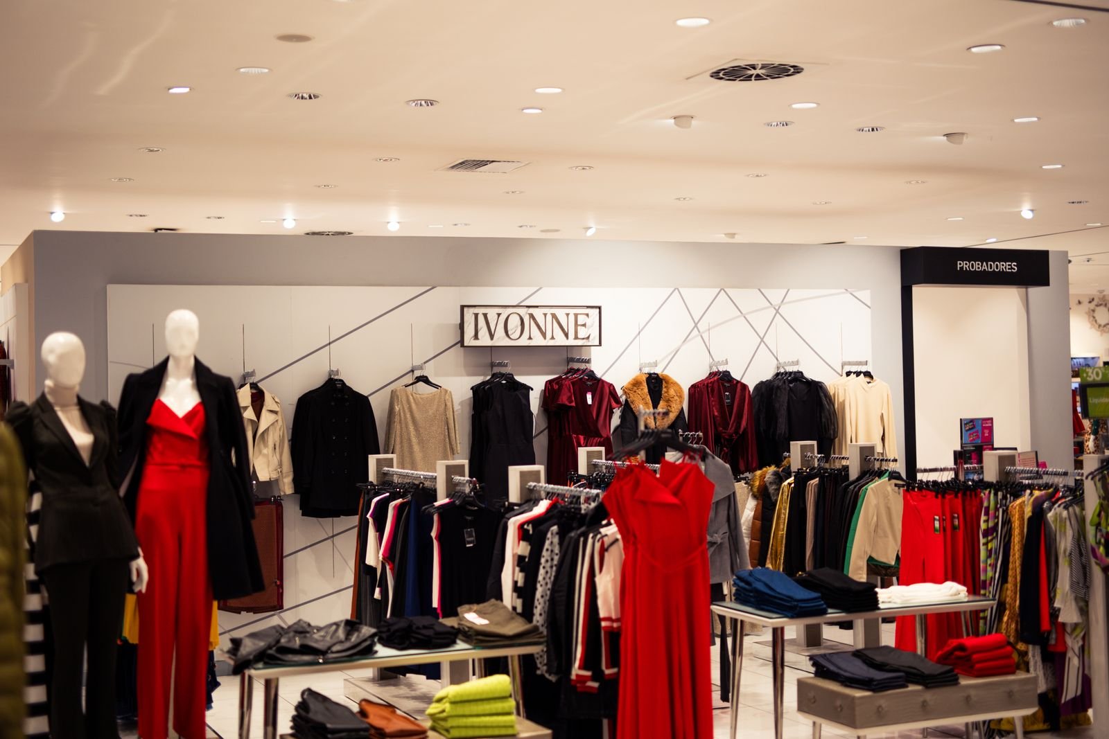 Fashion boutique interior with garments on racks under bright lighting