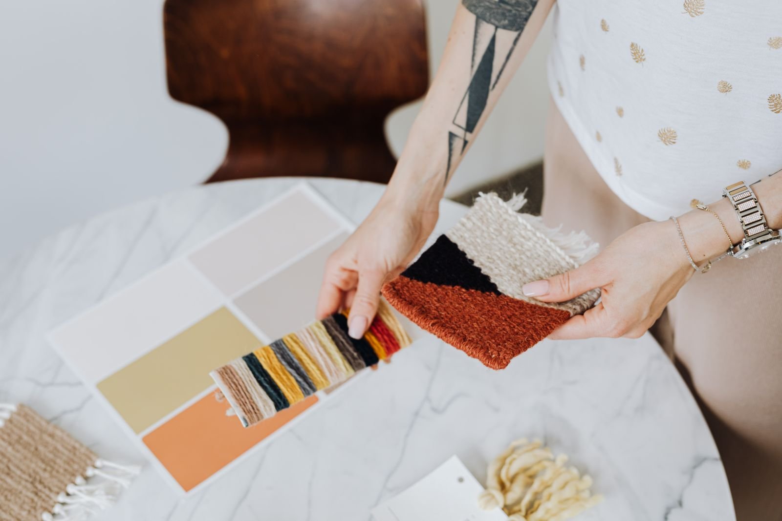 Woman choosing paint chips and material samples from a design sample library