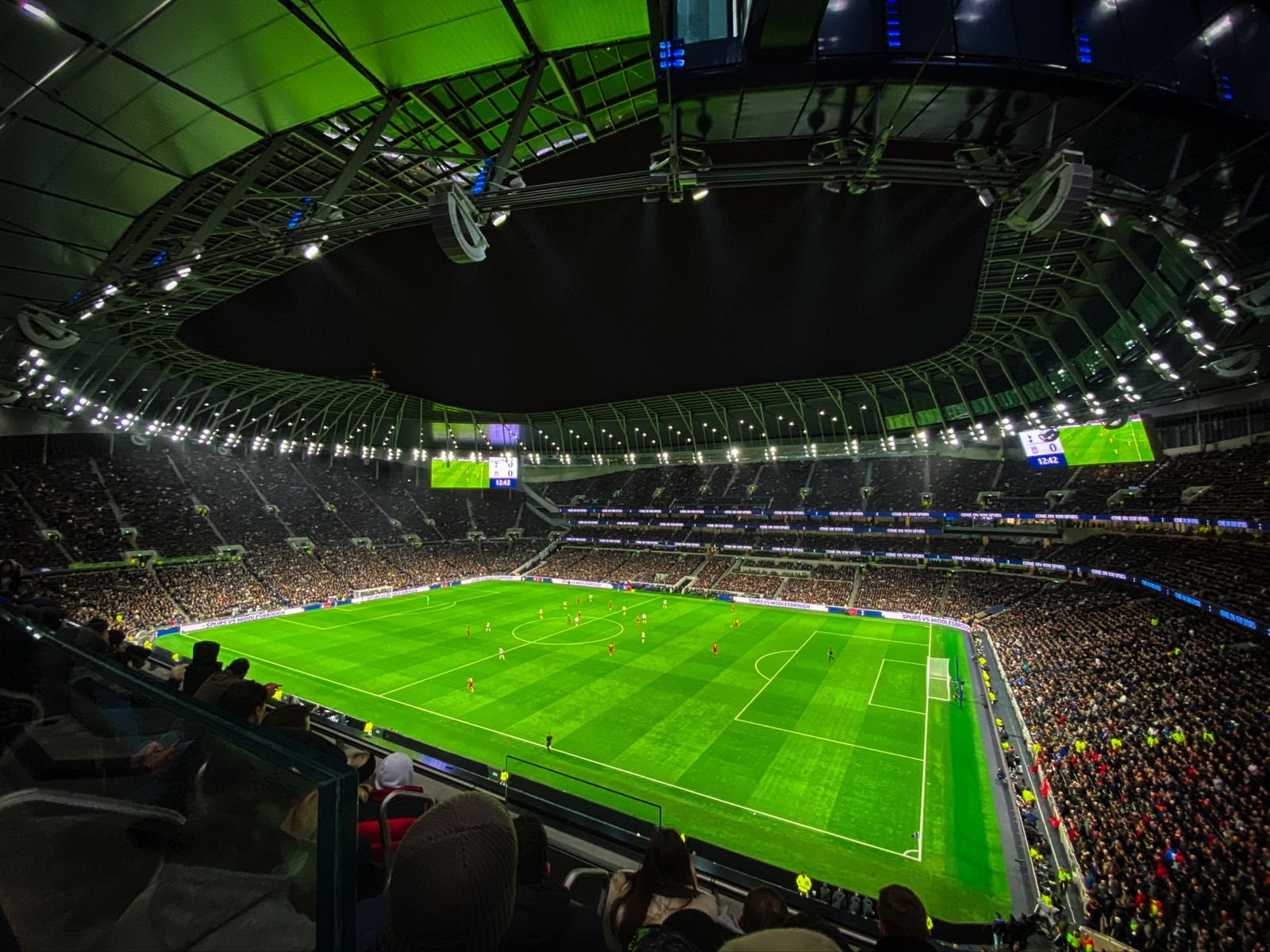 Spectators seated in rows of coloured stadium seats